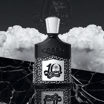 Elegant black perfume bottle with a white cap on marble surface.